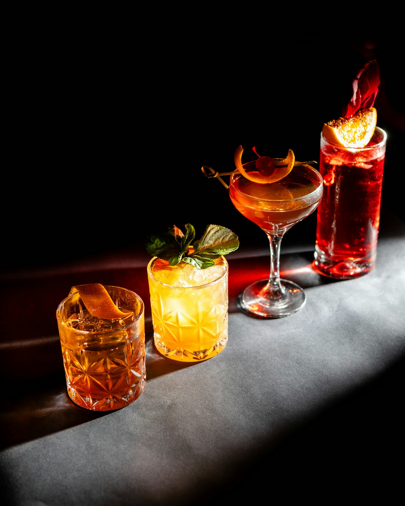 Colorful cocktails finished with fresh citrus and herbs